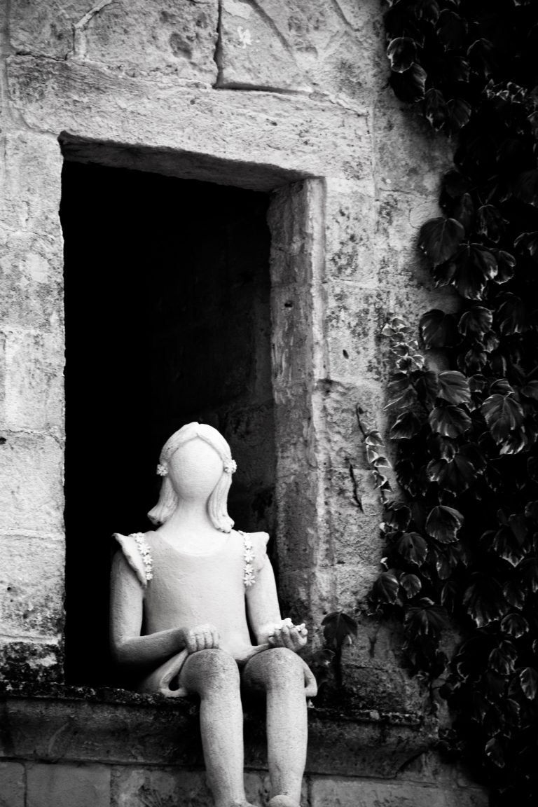 Statue at the entrance of an ancient dwelling of Matera