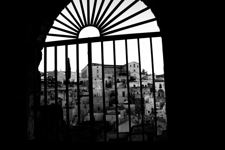 Black and white shadowed view of Matera through a grid