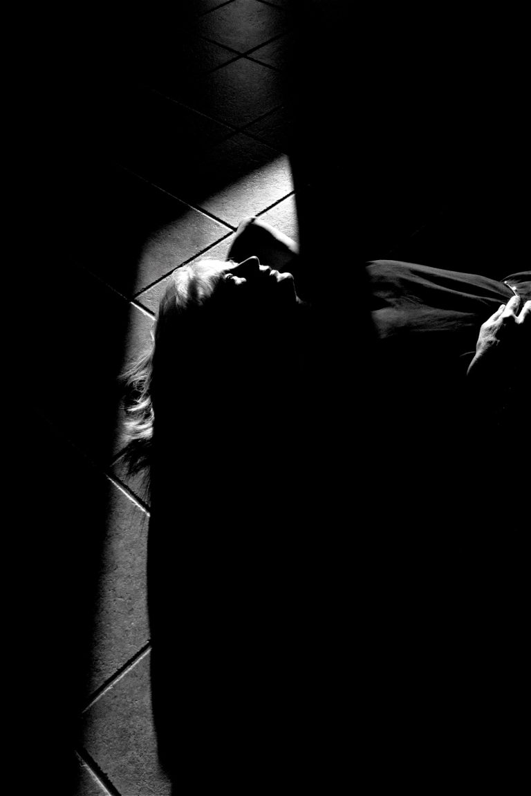 A girl lying on the ground thinking. Black and White photo