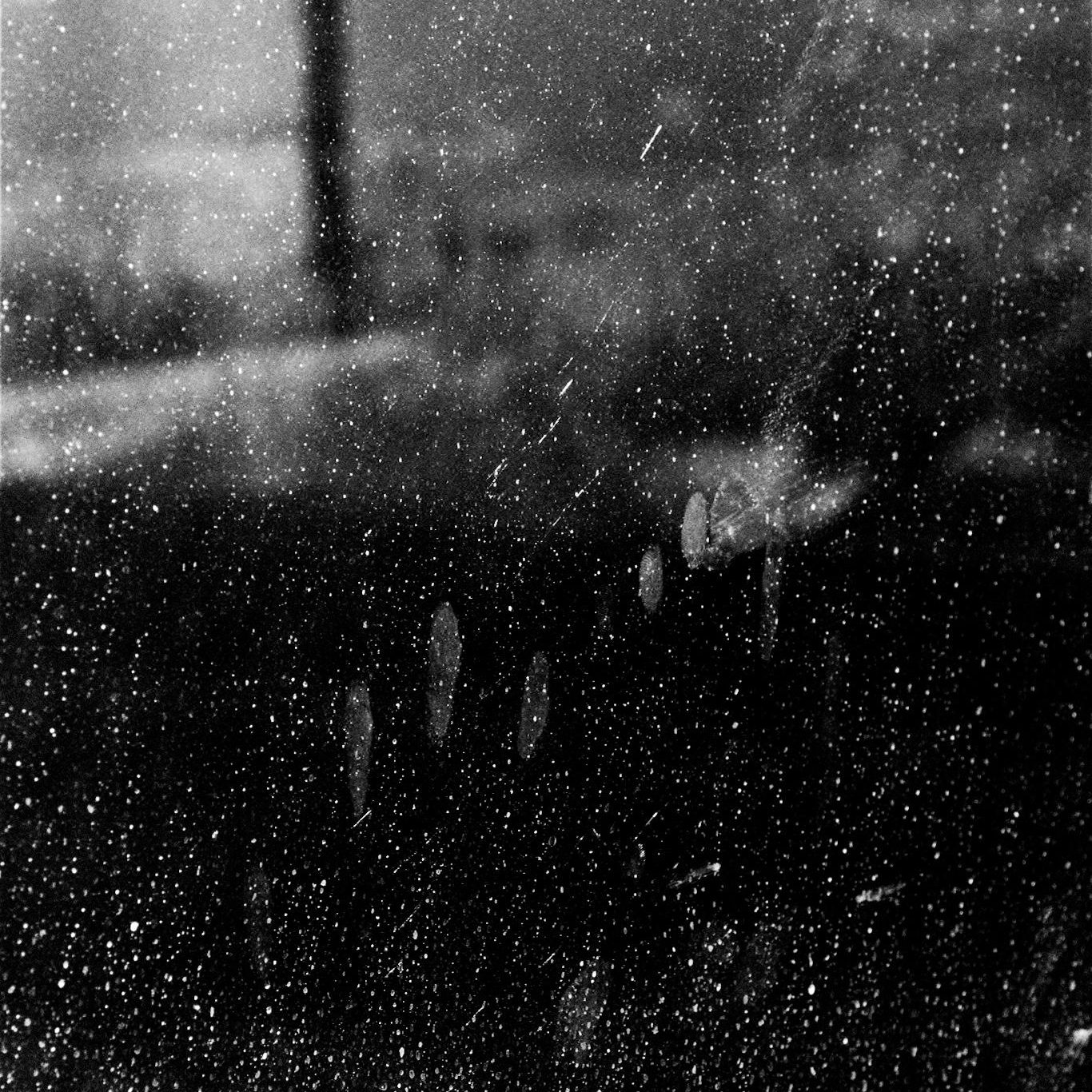 Artistic Black and white picture with the perspective of someone looking out of the window during a rainy day